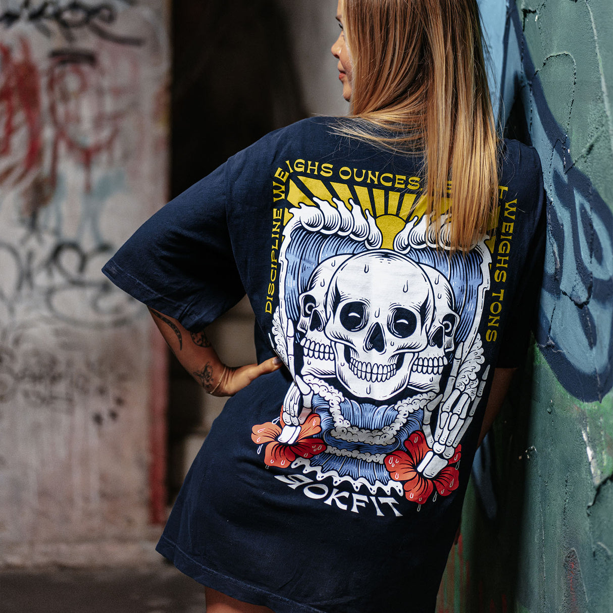 Female model wearing unisex Street Tee with 'Discipline Weighs Ounces' graphic