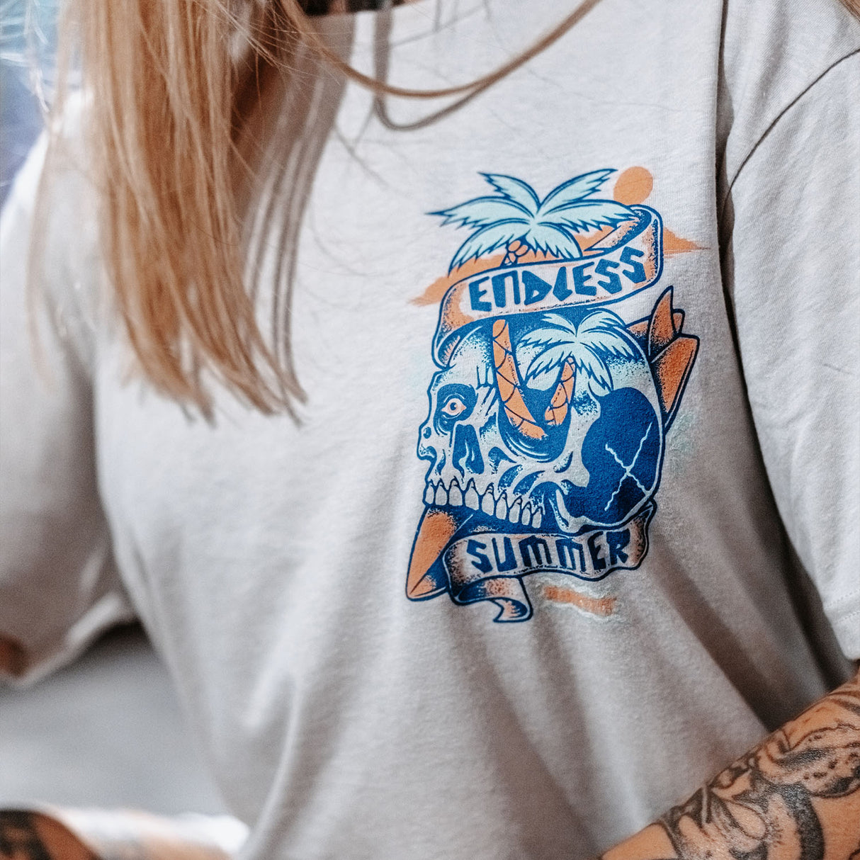 Female model wearing unisex Active Tee showing close up of the front view with 'Endless Summer' graphic