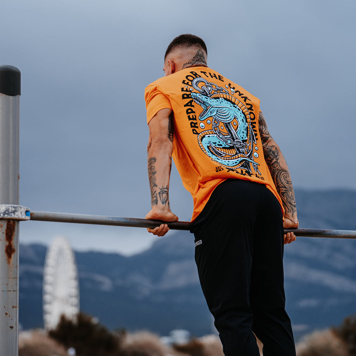Male model outdoors wearing unisex Active Tee with 'Prepare For The Unknown' graphic