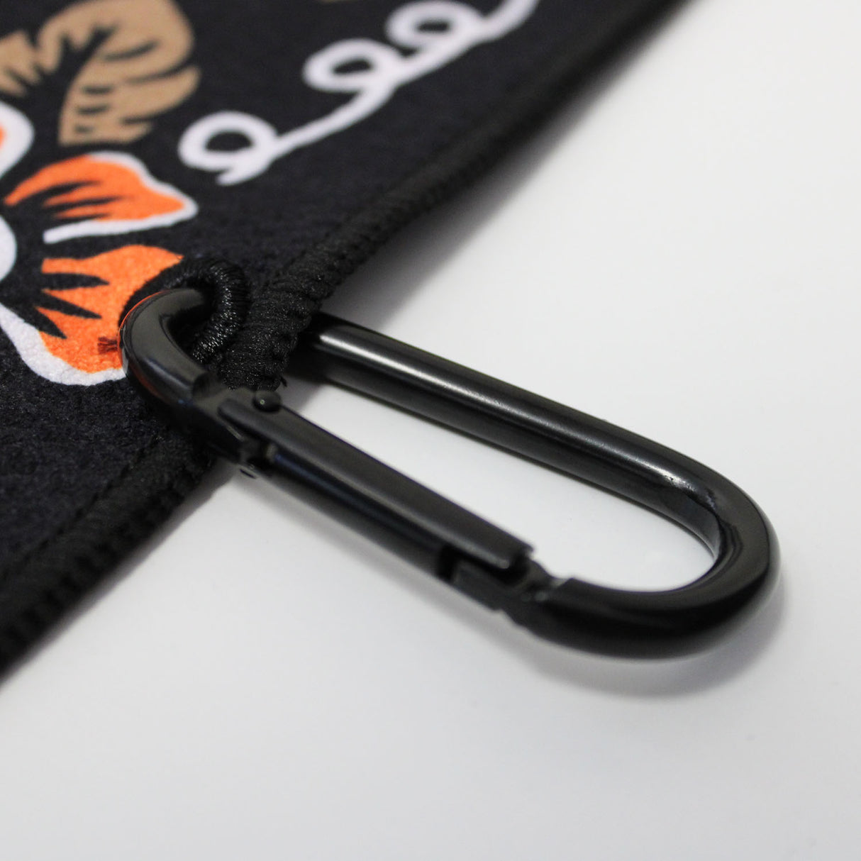 Close up of Utility Towel black carabiner clip with 'Train Insane or Remain the Same' graphic