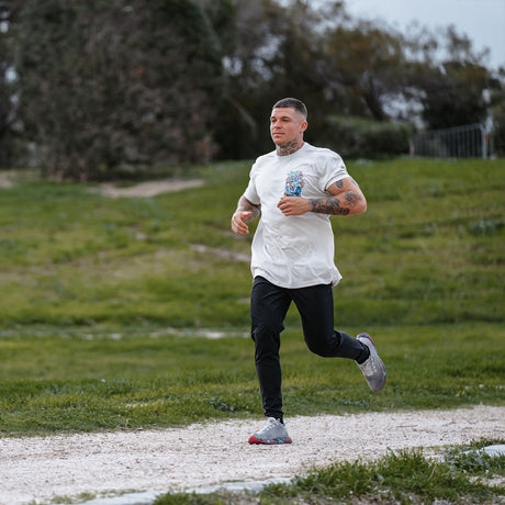 Male model outdoors running and wearing unisex Active Tee with 'Endless Summer' graphic
