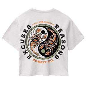 Back view of women's white crop top with 'Excuses or Reasons' graphic