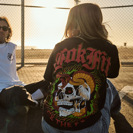 Female model outdoors wearing a unisex Street Tee with 'Face The Fury' graphic