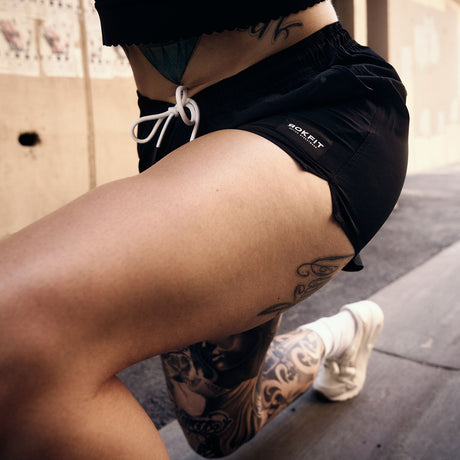 Female model in gym wearing women's black Hybrid Shorts