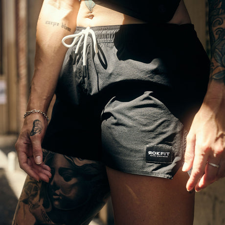 Female model outdoors wearing women's black Hybrid Shorts