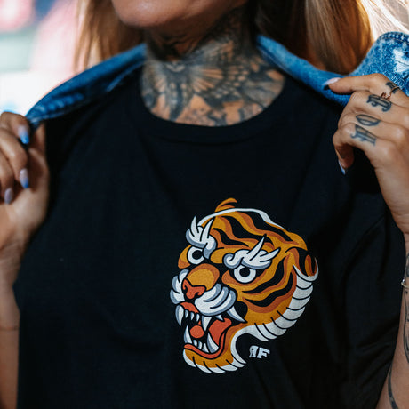 Female model outdoors wearing unisex Active Tee with 'Make Excuses or Make Progress' graphic